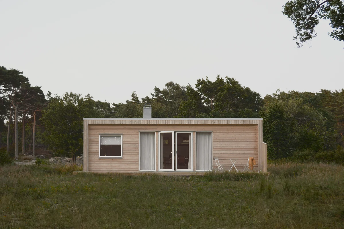 Compact home 38 sqm with wood panel in a garden by a forest